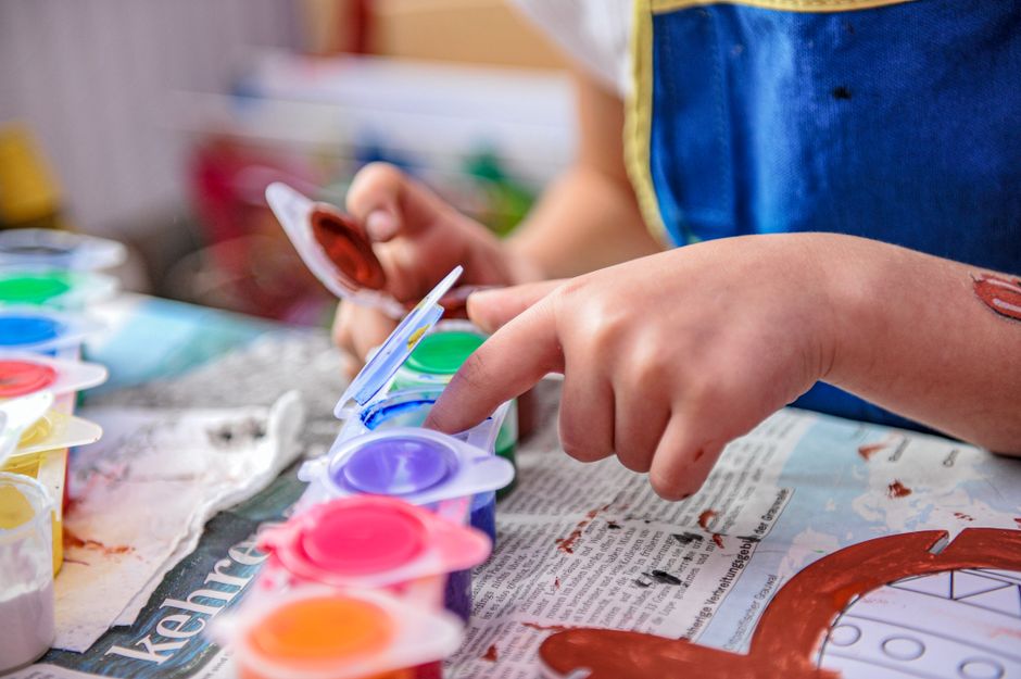 child finger painting