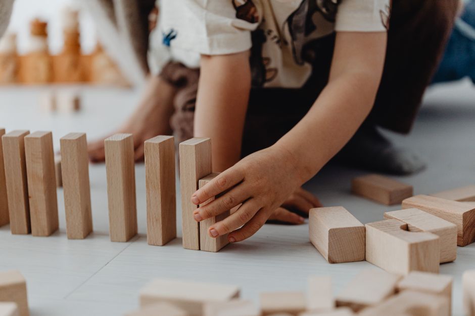 child playing wooden blocks