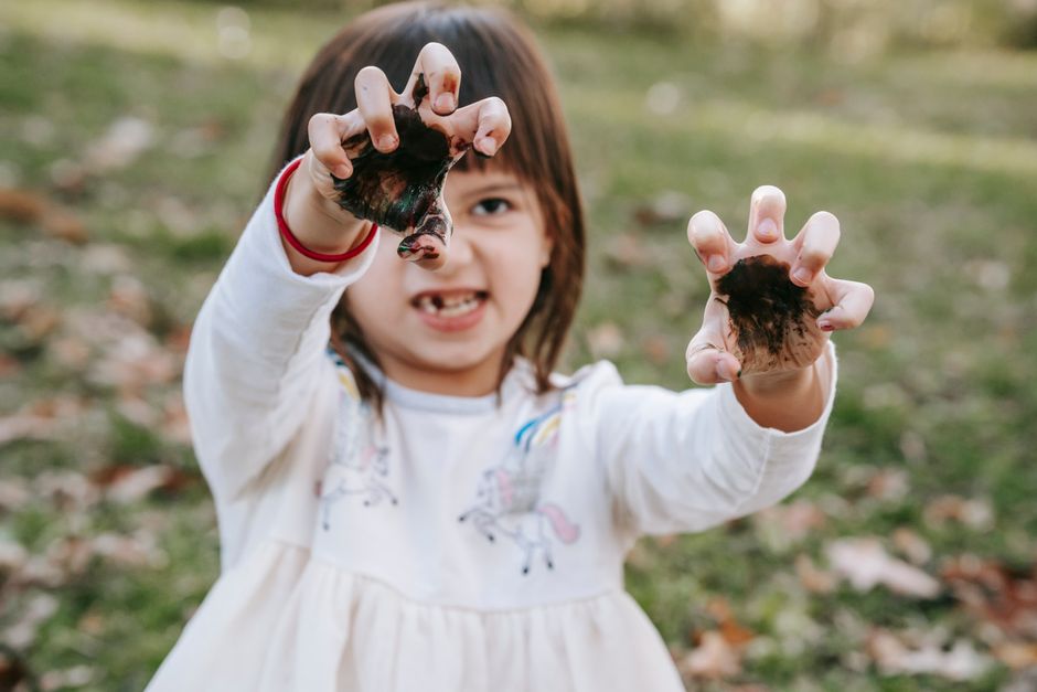 child playing in mud