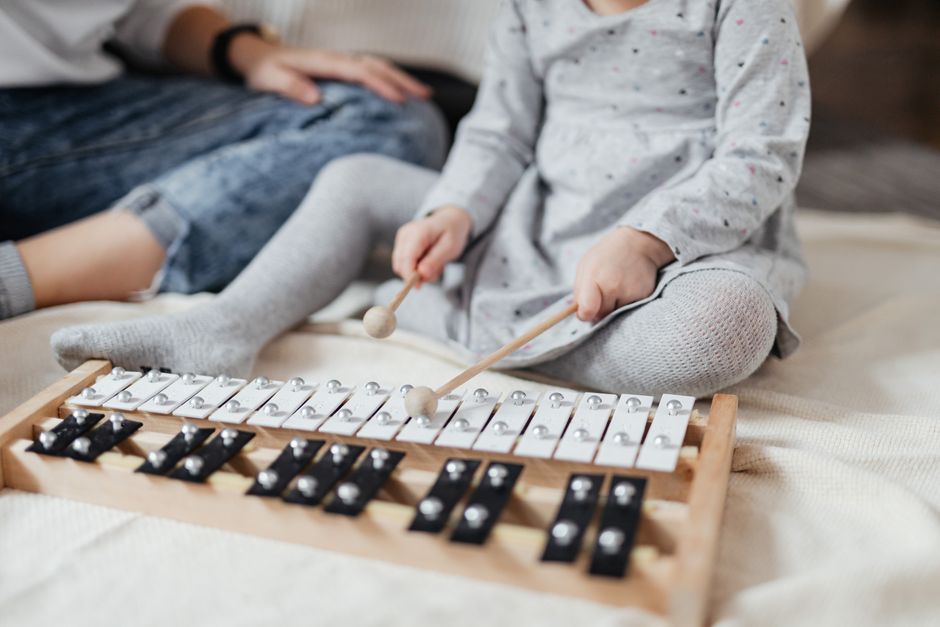 young child playing xylophone