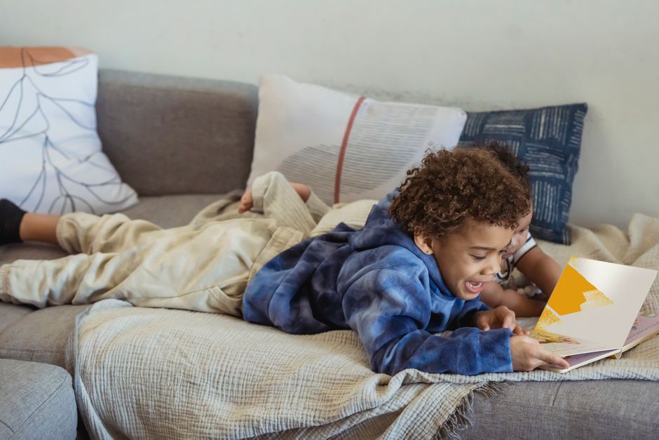kid reading on couch