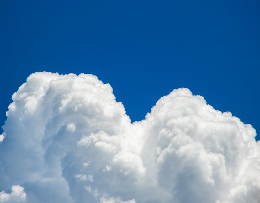 fluffy white clouds in blue sky