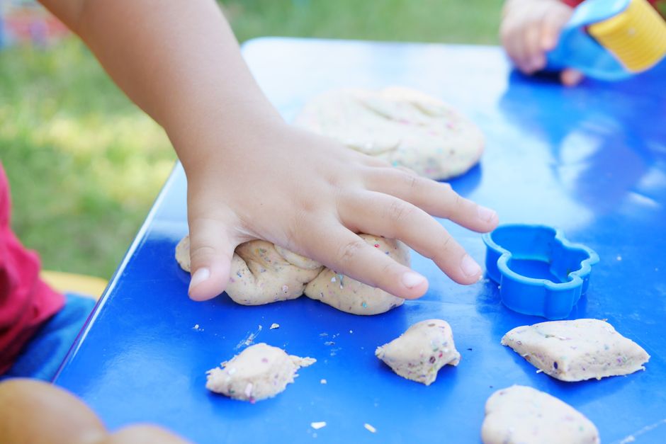 kids hands molding clay