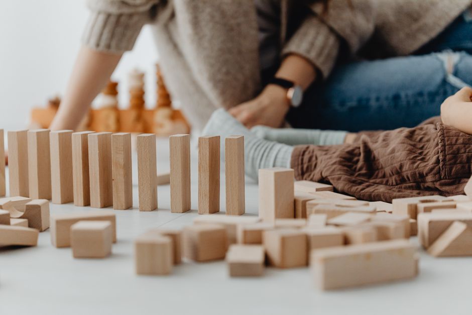 child playing wooden building blocks