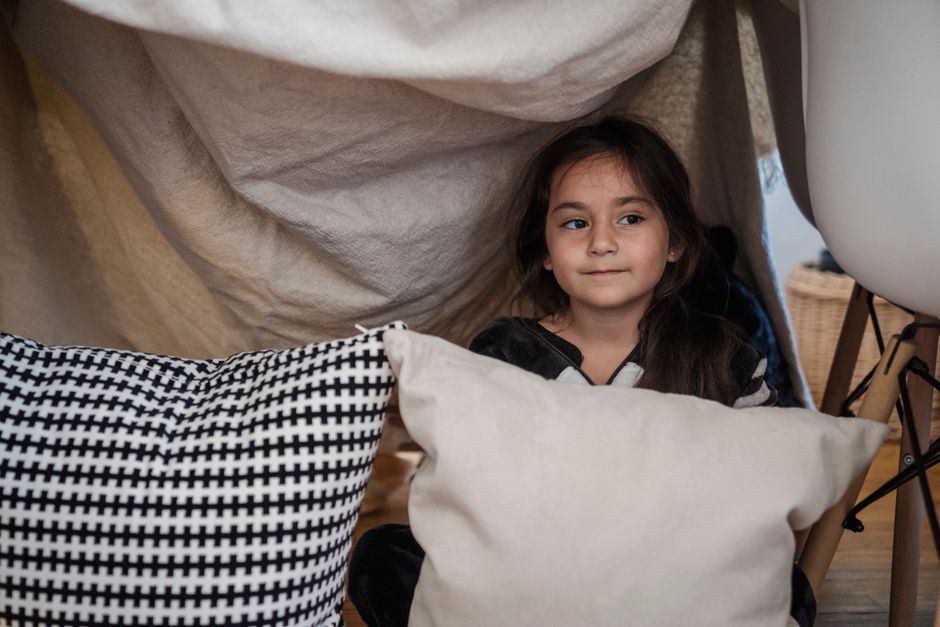 child building blanket fort