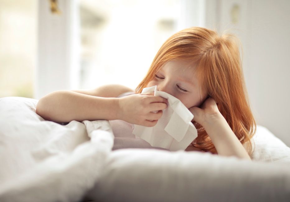 child sneezing tissue