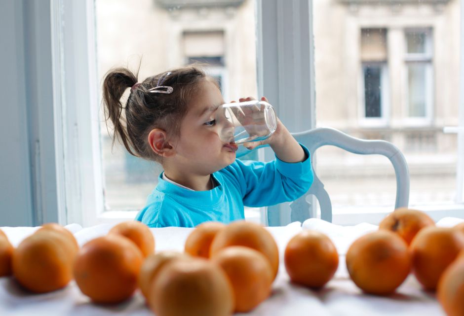 child drinking glass of water