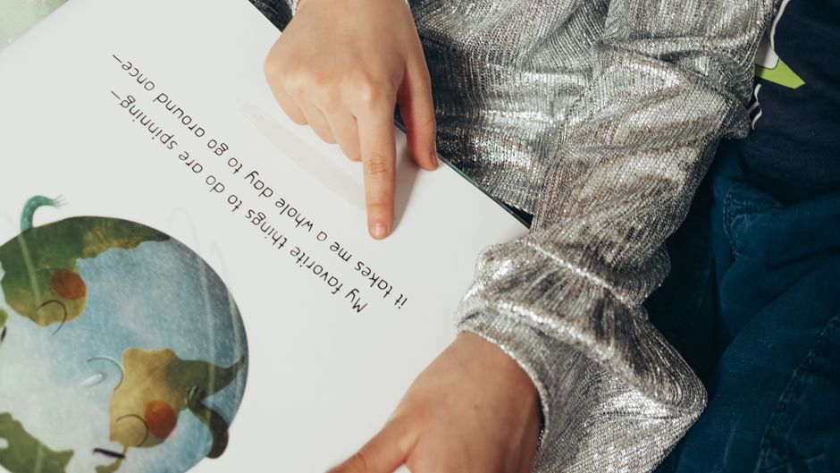 child reading book wonder